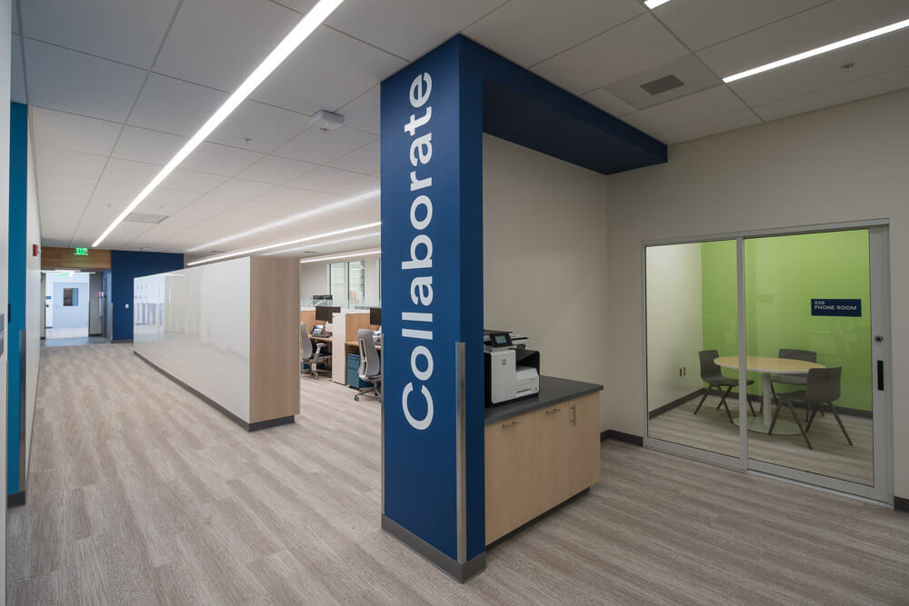 Interior photo of offices at Alaska Airlines Maintenance & Operations Facility with Collaborate written on the wall.