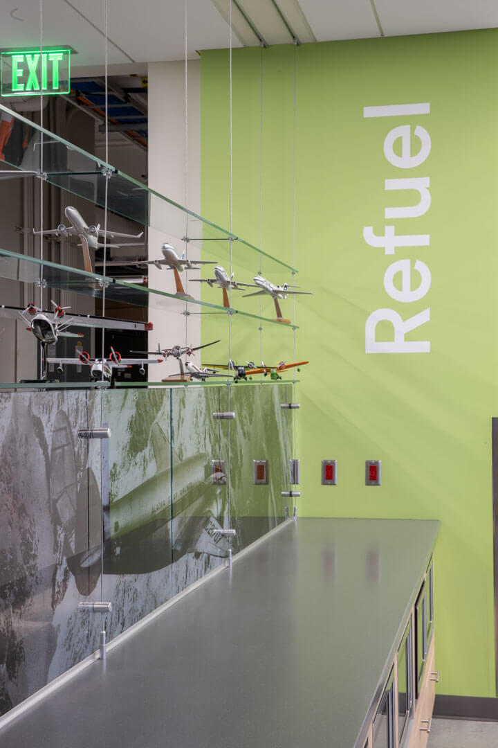 Interior photo of the Alaska Airlines Maintenance & Operations Facility with display of model airplanes and Refuel written on the wall.