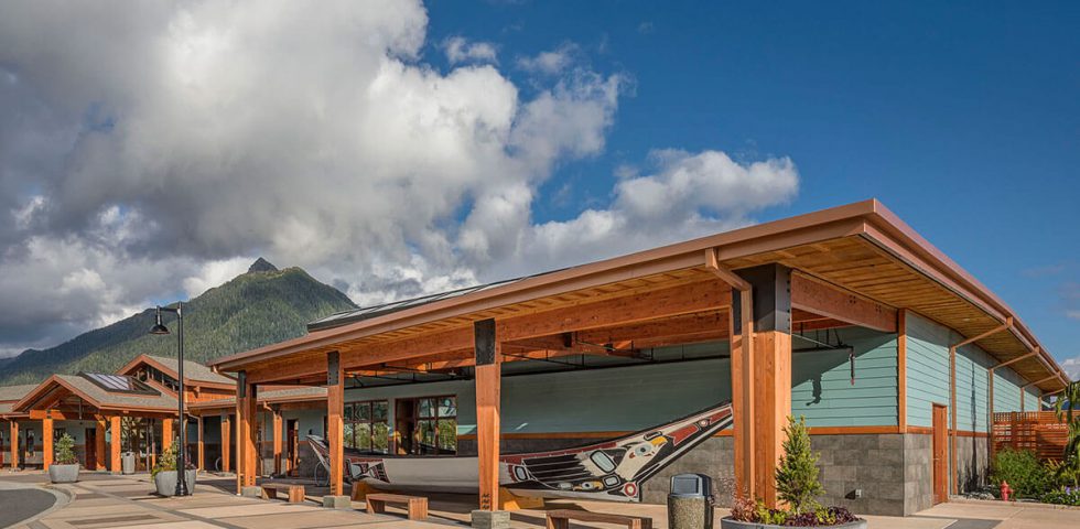 Exterior view of the Harrigan Centennial Hall with traditional canoe art installation.