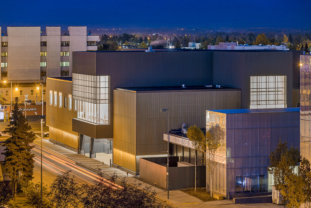 Exterior view at night of the Anchorage Museum Expansion