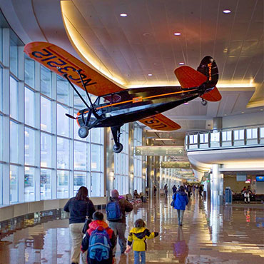 Bush plane hanging from the ceiling inside of the Ted Stevens International Airport C Terminal